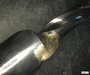 Excess braze around carbide insert on cutting tool (5x)